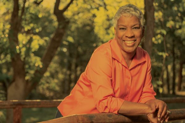 woman leaning on a fence
